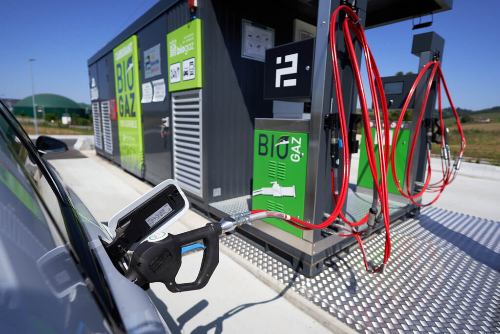 A imagem mostra um posto de combustível, onde são utilizadas as mangueiras GNV.